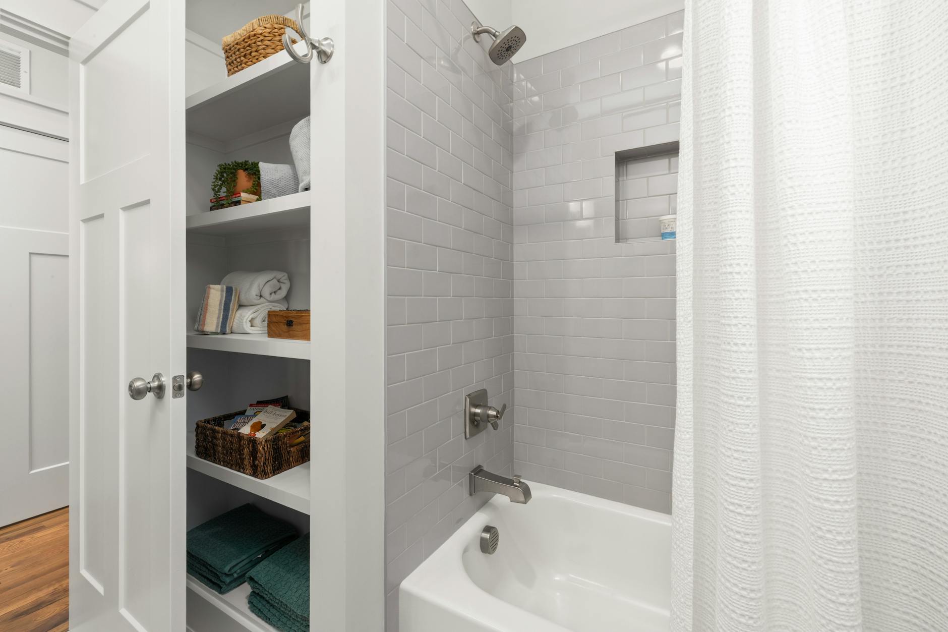A bathroom storage visual with shelves, baskets, and under-sink organization