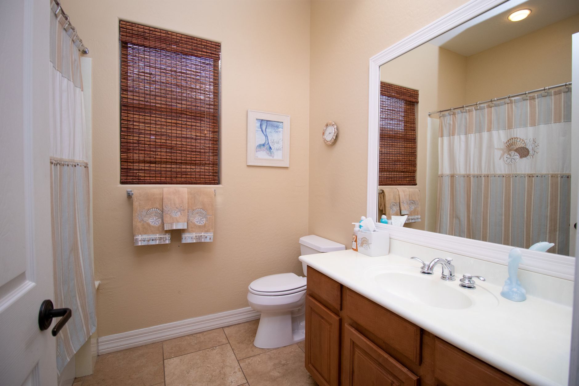 Bright and clean bathroom with a ceramic sink and stylish decor.