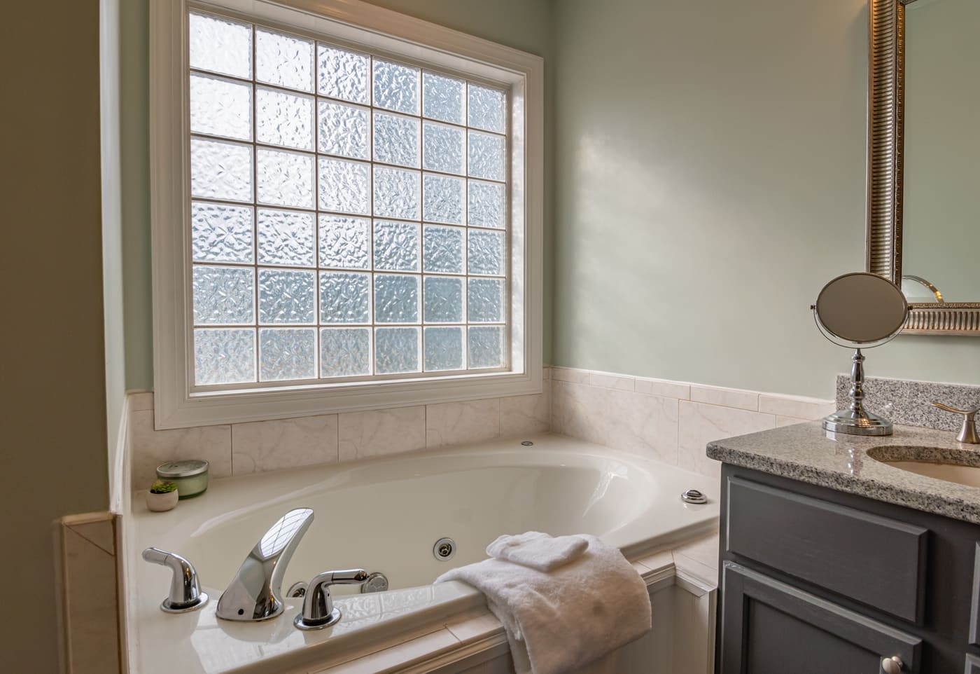 Bathroom with a bathtub and window letting in natural light