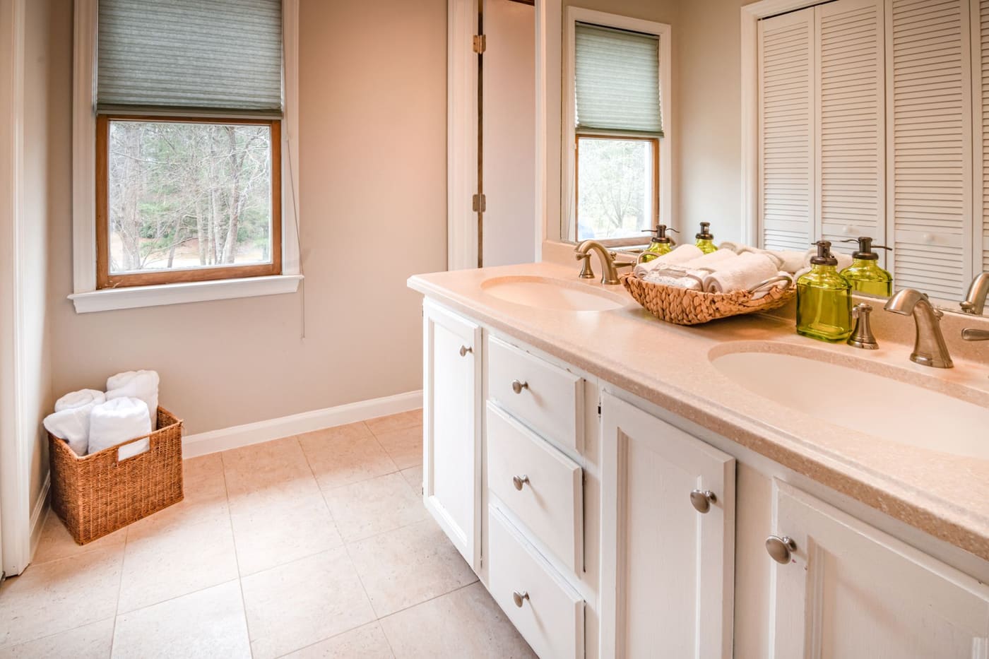 Double sink vanity with a basket of towels
