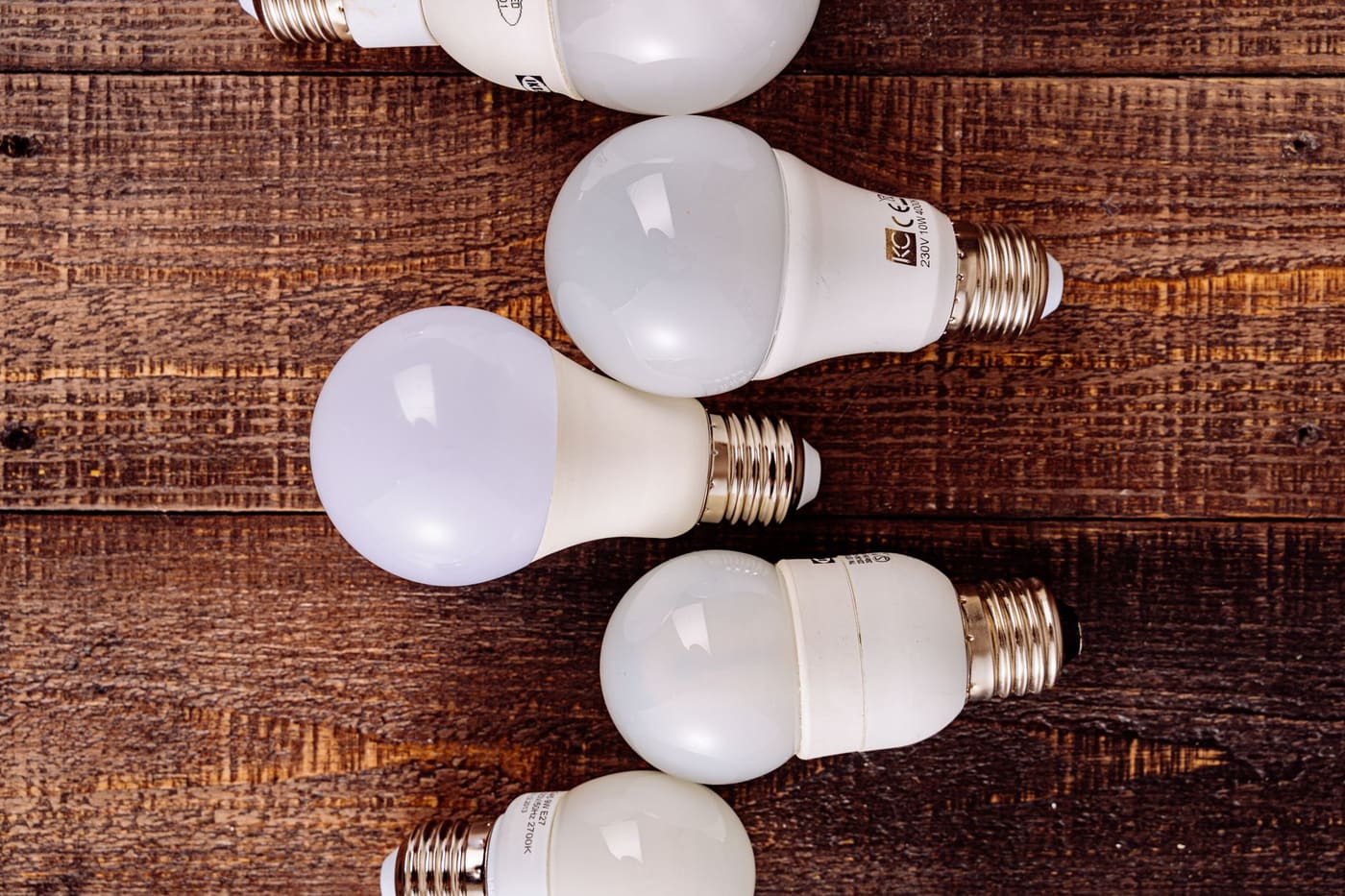 Frosted LED bulbs lying on a wooden surface