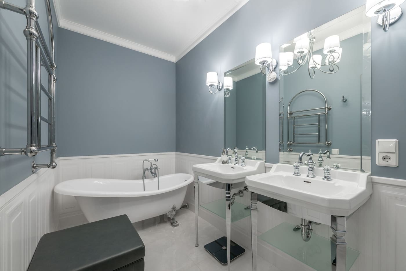 Bathroom vanity with a wall sconce on each side of a mirror