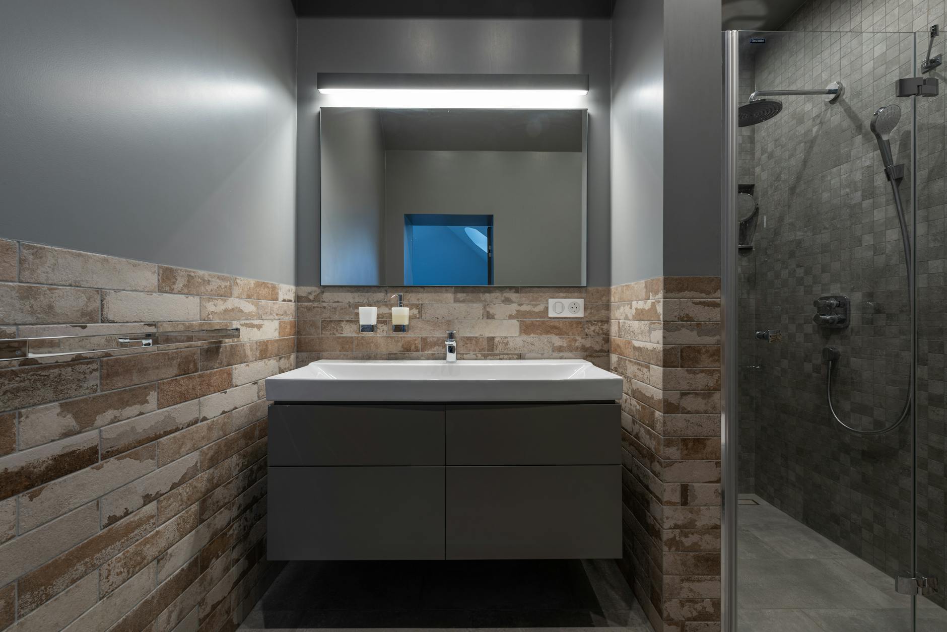 A bathroom lighting visual focused on mirrors and soft layered light